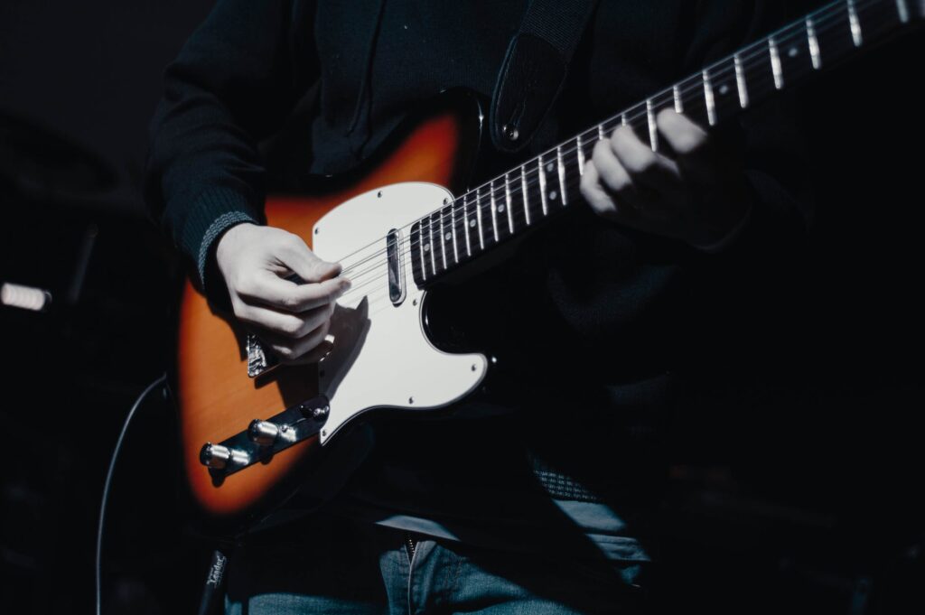 a person is playing electric guitar