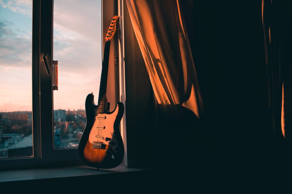 guitar beside window